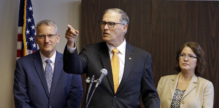 Washington Gov. Jay Inslee, center, addresses a news conference as state Health Secretary John Wiesman, left, and Ecology Director Maia Bellon look on Thursday, Oct. 8, 2015, in Seattle. Inslee directed state officials to attempt another rewrite of the state’s clean-water rules, as the state races to finalize a plan before the federal government does it for Washington. The contentious rule has pitted tribes against major businesses such as Boeing. (AP Photo/Elaine Thompson)