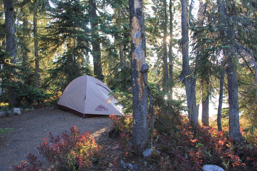ADVANCE FOR WEEKEND EDITIONS, OCT. 10-11 - This photo taken Sept. 8, 2015, shows a camping spot on Berry Island on Summit Lake in the Deschutes National Forest near Oakride, Ore. Summit Lake is one of the great secret places in the Cascade Mountains not just because of its islands, but also because of the clear water and views of Diamond Peak. (Zach Urness/Statesman-Journal via AP) MANDATORY CREDIT