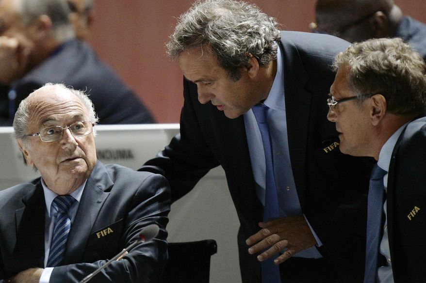 FILE - In this May 29, 2015 file photo FIFA President Sepp Blatter, left, UEFA President Michel Platini, center, and FIFA Secretary General Jerome Valcke, right, are engaged in conversation during the 65th FIFA Congress held at the Hallenstadion in Zurich, Switzerland. On Thursday, Oct. 8, 2015 file photo FIFA provisionally banned President Sepp Blatter, UEFA President Michel Platini and the former secretary general Valcke for 90 days. (Walter Bieri/Keystone via AP)