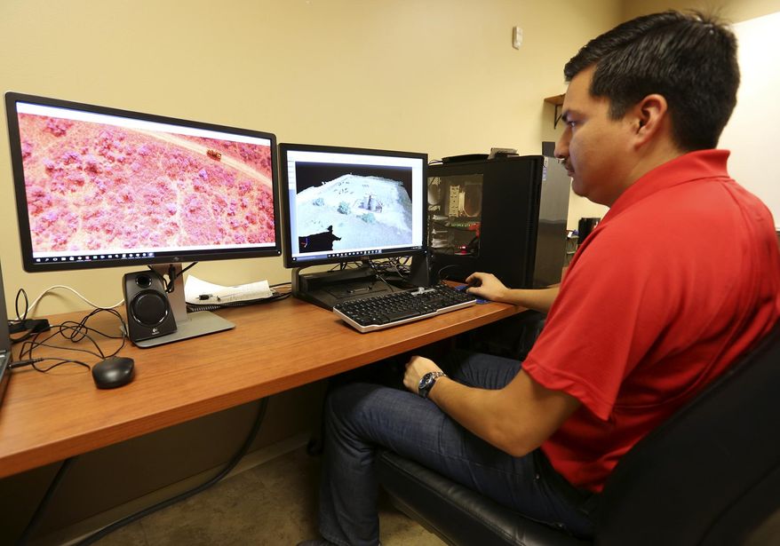 ADVANCE FOR USE SUNDAY, OCT. 11 - In this photo taken Sept. 23, 2015, Frank Hurtado shows some of the footage Midstream Integrity has taken during their oil field survey work in San Antonio, Texas. Midstream Integrity is an FAA-approved drone service provider specializing in the oil and gas industry services. (William Luther/The San Antonio Express-News via AP) RUMBO DE SAN ANTONIO OUT; NO SALES; MANDATORY CREDIT
