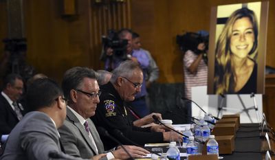 Jim Steinle, second from left, father of Kathryn Steinle, in photograph, testifies next to Montgomery County (Md.) Police Department. Chief J. Thomas Manger, right, before a Senate Judiciary hearing to examine the Administration&#x27;s immigration enforcement policies, in Washington, Tuesday, July 21, 2015. Kathryn Steinle was killed on a San Francisco pier, allegedly by a man previously deported several times. (AP Photo/Molly Riley) ** FILE **