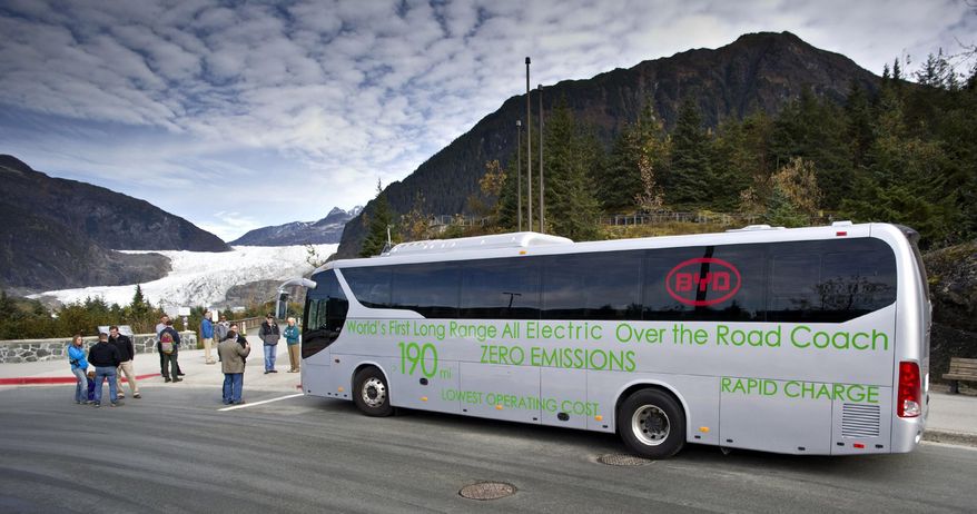 In this photo taken Tuesday, Oct. 6, 2015, an electric motor coach provided by BYD Auto Co., Ltd., a Chinese automobile manufacturer and Alaska Coach Tours stops at the Mendenhall Glacier Visitors Center in Juneau, Alaska. A group of about 20 people took a short tour to the glacier. The tour was considerably different than most: The tour bus — not the glacier — was the center of attention. (Michael Penn/Juneau Empire via AP)