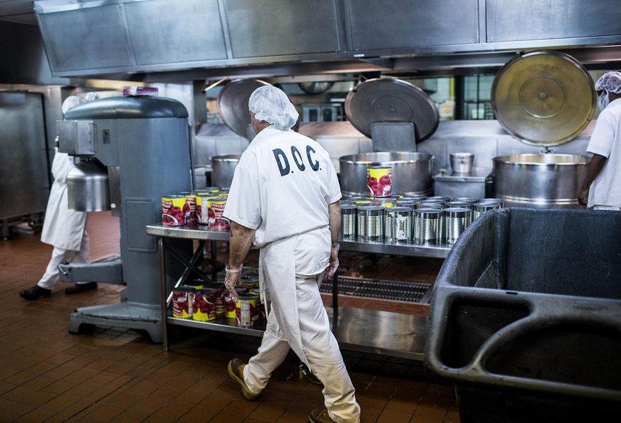 ADVANCE FOR USE SATURDAY, OCT. 10 - In this photo taken Aug. 29, 2015, inmates work in the kitchen at the State Correctional Institution in Coal Township, Pa. Even though some victims and others might begrudge giving inmates more than a bread and water diet, a lot of thought, attention and planning goes into feeding 51,000 inmates in Pennsylvania's state prisons. (Sean Simmers/PennLive.com via AP) MANDATORY CREDIT