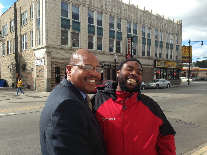 In this Sept. 30, 2015 photo, Autry Phillips, left, director of Target Area Development in Chicago’s Auburn Gresham neighborhood, talks with area resident Justin Garner, 27, during a walk along 79th Street. Illinois Gov. Bruce Rauner froze funding for the anti-violence program Operation CeaseFire because of the state budget crisis, forcing Target Area and other organizations to shut down the program at a time of year when shootings spike. (AP Photo/Sara Burnett)