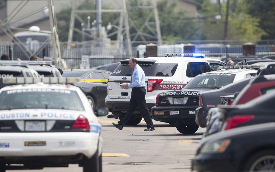 Houston Police vehicles respond after a shooting at Texas Southern University, Friday, Oct. 9, 2015, in Houston. A student was killed and another person was wounded in a shooting outside a student-housing complex on Friday, and police have detained at least two people, authorities said. (Cody Duty/Houston Chronicle via AP) MANDATORY CREDIT
