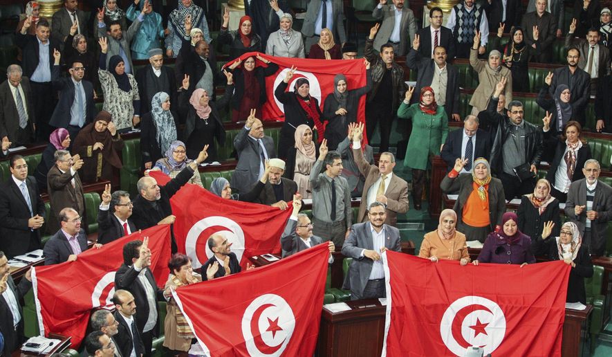 FILE - In this Sunday, Jan. 26, 2014 file photo, members of the Tunisian National Constituent Assembly celebrate the adoption of the new constitution in Tunis, Tunisia. A Tunisian democracy group won the Nobel Peace Prize on Friday for its contributions to the first and most successful Arab Spring movement. The Norwegian Nobel Committee cited the Tunisian National Dialogue Quartet &amp;quot;for its decisive contribution to the building of a pluralistic democracy&amp;quot; in the North African country following its 2011 revolution. (AP Photo/Aimen Zine, File)