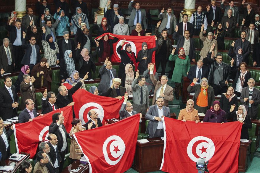 FILE - In this Sunday, Jan. 26, 2014 file photo, members of the Tunisian National Constituent Assembly celebrate the adoption of the new constitution in Tunis, Tunisia. A Tunisian democracy group won the Nobel Peace Prize on Friday for its contributions to the first and most successful Arab Spring movement. The Norwegian Nobel Committee cited the Tunisian National Dialogue Quartet "for its decisive contribution to the building of a pluralistic democracy" in the North African country following its 2011 revolution. (AP Photo/Aimen Zine, File)