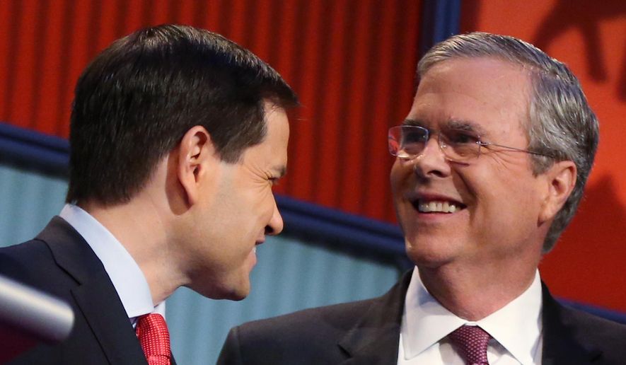 In this Aug. 6, 2015, file photo, Republican presidential candidates Marco Rubio, left, and Jeb Bush talk during a break during the first Republican presidential debate at the Quicken Loans Arena in Cleveland. (AP Photo/Andrew Harnik)