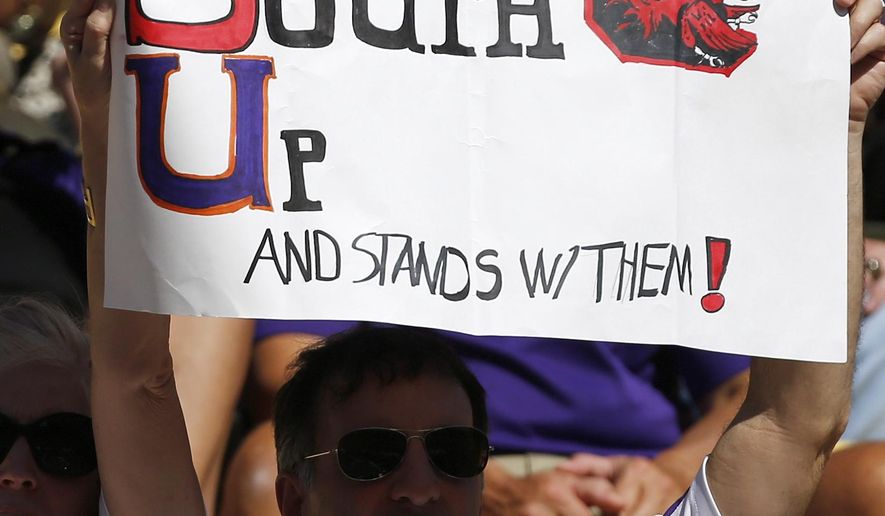 A fan holds a sign in support of South Carolina during the first half of an NCAA college football game against LSU in Baton Rouge, La., Saturday, Oct. 10, 2015. The game was moved from Columbia, S.C. to Baton Rouge because of flooding. (AP Photo/Jonathan Bachman)