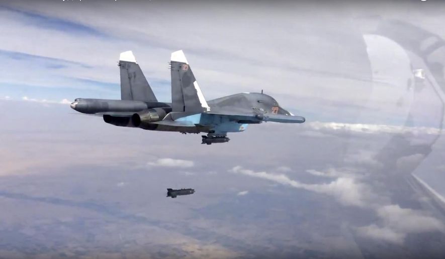 In this photo made from the footage taken from Russian Defense Ministry official web site on Friday, Oct. 9, 2015, a bomb is released from Russian Su-34 strike fighter in Syria. Activists report intense fighting between insurgents and Syrian troops in the country’s center amid new territorial gains for the government, backed by Russian airstrikes. (Russian Defense Ministry Press Service via AP)