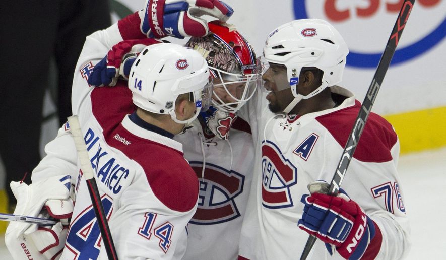 Montreal Canadiens defenseman P.K. Subban, right, and center Tomas Plekanec congratulate goalie Mike Condon as the Canadiens defeat the Ottawa Senators in an NHL hockey game, Sunday, Oct. 11, 2015 in Ottawa, Ontario. (Adrian Wyld/The Canadian Press via AP) MANDATORY CREDIT