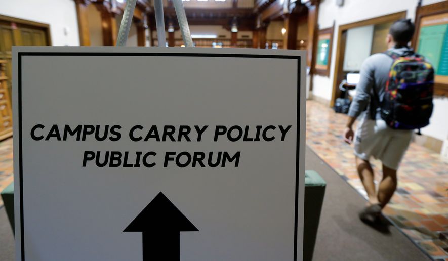 Students arrive a public forum on the University of Texas campus as a special committee studies how to implement a new law allowing students with concealed weapons permits to carry firearms into class and other campus buildings Sept. 30 in Austin, Texas. The law takes effect in August 2016. (Associated Press)