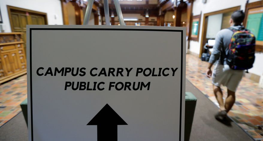 Students arrive a public forum on the University of Texas campus as a special committee studies how to implement a new law allowing students with concealed weapons permits to carry firearms into class and other campus buildings Sept. 30 in Austin, Texas. The law takes effect in August 2016. (Associated Press)