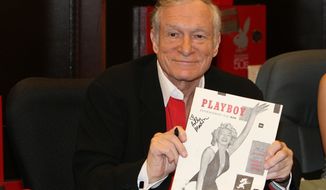 In this Nov. 15, 2007 photo, Hugh Hefner smiles while signing copies of the Playboy calendar and Playboy Cover To Cover: The 50&#39;s DVD box set in Los Angeles. Playboy will no longer publish photos of nude women as part of a redesign of the decades-old magazine, according to a news report Monday, Oct. 12, 2015. Executives for the magazine company told The New York Times that the change will take place in March 2016. Playboy editor Cory Jones contacted founder and current editor in chief Hugh Hefner recently about dropping nude photos from the print edition and he agreed, the Times reported. (Ian West/PA via AP)  UNITED KINGDOM OUT