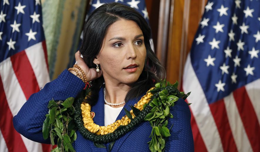 Rep. Tulsi Gabbard, Hawaii Democrat, claimed she was disinvited to Tuesday&#x27;s debate in Las Vegas because she criticized the decision to strictly limit the number of Democratic presidential debates to six. (Associated Press)