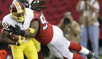 Washington Redskins wide receiver Jamison Crowder (80) runs as Atlanta Falcons defensive end Adrian Clayborn (99) makes the tackle during the first half of an NFL football game, Sunday, Oct. 11, 2015, in Atlanta. (AP Photo/Brynn Anderson)

