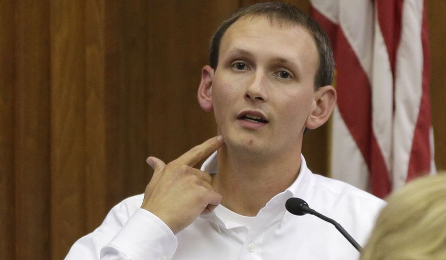 Milwaukee Police Officer Bryan Norberg describes being shot while testifying in court during the Badger Guns trial in a Milwaukee on Oct. 5. (Milwaukee Journal-Sentinel via Associated Press)