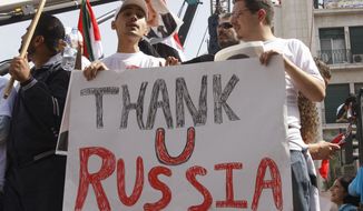 Supporters of the Syrian government hold a pro-Russian banner as they show their support for Syrian President Bashar Assad and to thank Russia and China for blocking a U.N. Security Council resolution condemning Syria for its brutal crackdown, during a demonstration in Damascus, Syria, in this Oct. 12, 2011, file photo. Russian President Vladimir Putin is winning plaudits from many Syrians and Iraqis, who see Russia&#39;s military intervention in Syria as a turning point after more than a year of largely ineffectual efforts by the U.S.–led coalition battling the Islamic State group. (AP Photo/Muzaffar Salman, File)

