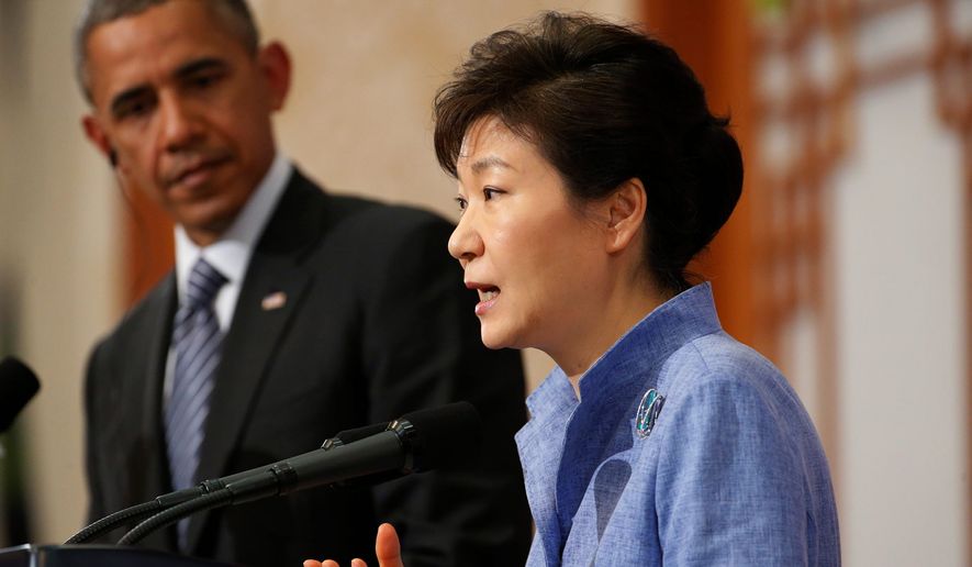 U.S. President Barack Obama listens as South Korean President Park Geun-hye speaks during a joint news conference at the Blue House in Seoul, South Korea, Friday, April 25, 2014. Obama, continuing his four-nation Asia trip which began in Japan, underscored warnings against North Korean nuclear provocations, calls to lower tensions in regional territorial disputes, and words of condolence for the ferry disaster victims and the people of South Korea. (AP Photo/Charles Dharapak)