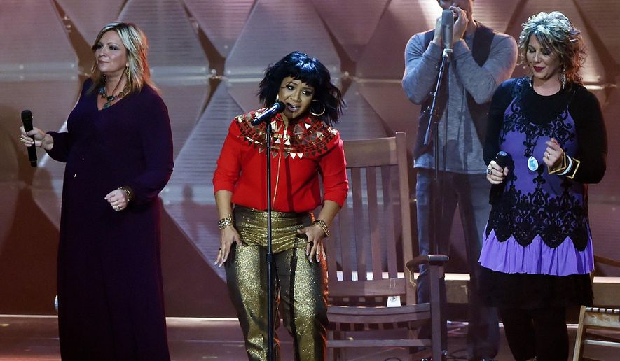 Erica Campbell, center, performs during the Dove Awards Tuesday, Oct. 13, 2015, in Nashville, Tenn. (AP Photo/Mark Zaleski)