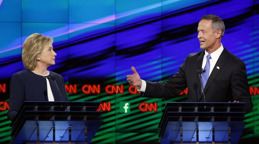 Former Maryland Gov. Martin O'Malley, right, speaks as Hillary Rodham Clinton listens during the CNN Democratic presidential debate Tuesday, Oct. 13, 2015, in Las Vegas. (AP Photo/John Locher)