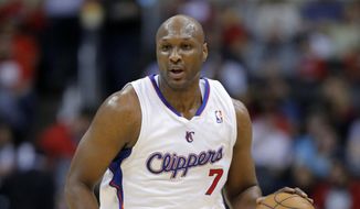 Los Angeles Clippers&#39; Lamar Odom brings the ball up in an NBA basketball game against the Phoenix Suns in Los Angeles, in this Dec. 8, 2012, file photo. Odom, the former NBA star and reality TV personality embraced by teammates and fans alike for his humble approach to fame, was hospitalized after being found unresponsive in a Nevada brothel where he had been staying for days. (AP Photo/Jae C. Hong/File)