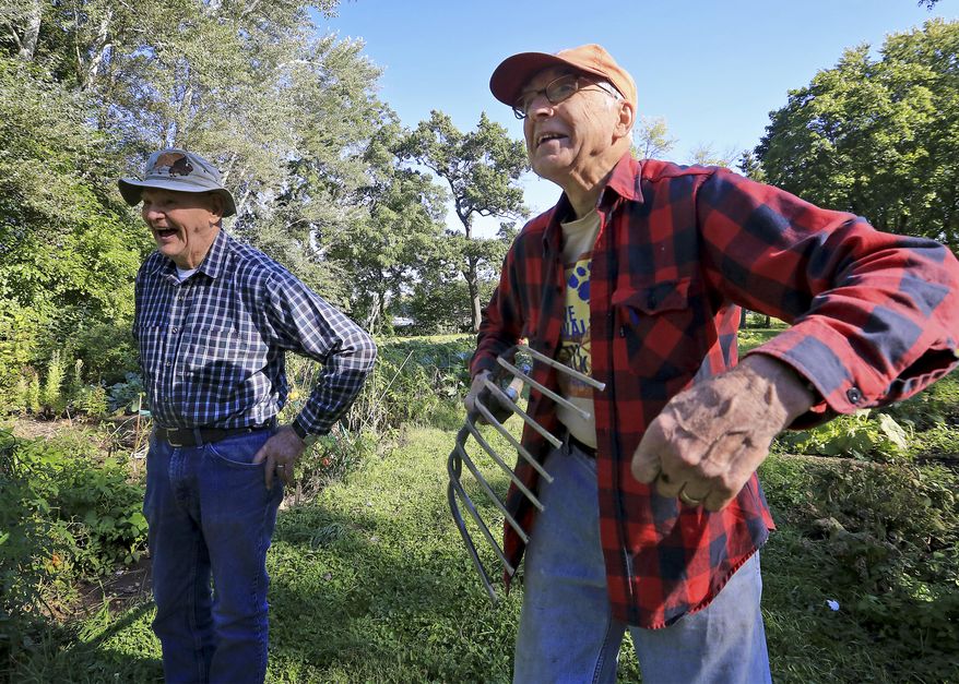 Len Riha, 87, left, and John Sheild, 84, tend a garden on the grounds of the San Damiano friary in Monona, Wis. on Sept. 21, 2015. As the gardening season comes to an end, uncertainty fills the air. The Catholic order of priests that owns the friary has said it may sell the property. The nearly 10-acre site on Lake Monona housed semi-retired priests for decades, until this spring when the last one moved out. ( John Hart/Wisconsin State Journal via AP) MANDATORY CREDIT