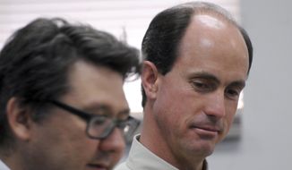 In this July 9, 2015, photo, Seth Jeffs, right, the brother of Warren Jeffs, the imprisoned leader of a polygamist sect, participates in a state water board meeting in Pierre, S.D. South Dakota regulators approved Wednesday, Oct. 14, 2015, the secretive polygamist group&#39;s request to draw water more quickly at its Black Hills compound even though the sect declined to provide many details about how many people live there. (AP Photo/James Nord, File)
