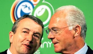 FILE - In this March 6, 2006 file photo German soccer legend and head of the organizing committee for the 2006 soccer World Cup in Germany, Franz Beckenbauer, right, talks to Wolfgang Niersbach during a workshop in the build up for the World Cup in Düsseldorf, western Germany.  (AP Photo/Frank Augstein, file)