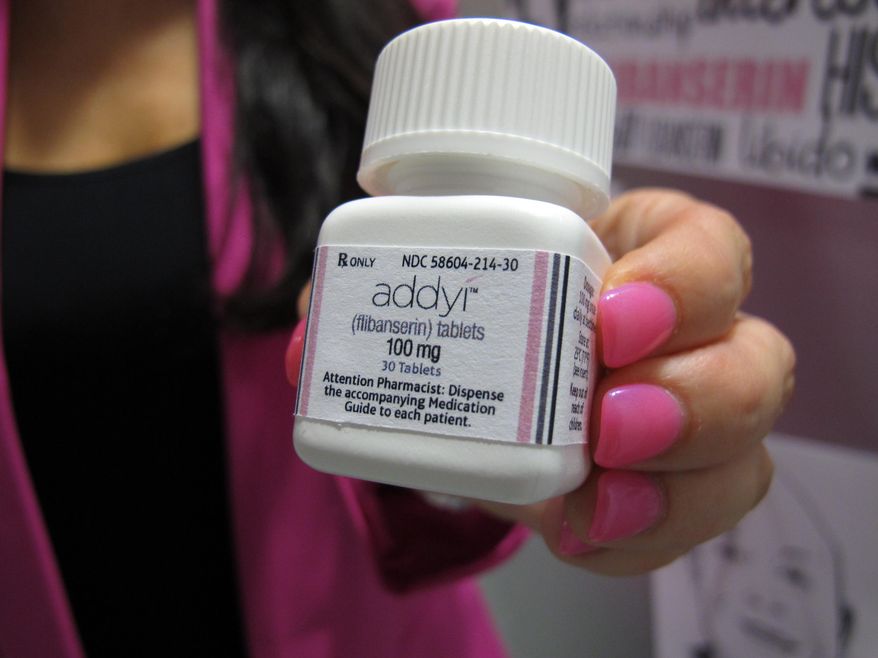 FILE - In this Aug. 18, 2015 file photo, Sprout Pharmaceuticals CEO Cindy Whitehead holds a bottle for the female sex-drive drug Addyi at her Raleigh, N.C. Most women with low sexual desire won’t rush out to get the first prescription drug to boost female libido when it launches on Saturday, Oct. 17, 2015. But they may have more options down the road. (AP Photo/Allen G. Breed)