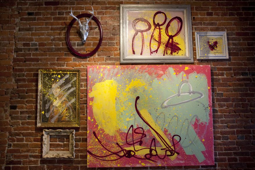 In this photo taken May 13, 2015, “Watermelon Nessie & Neil Peart’s Spaceship” by Port Huron artist Ryan Nisbitt is on display at Kate’s Downtown as part of Art Hop in Port Huron, Mich. The hustle and bustle of downtown Port Huron comes to life during Art Hop twice a year, and shops and artists are gearing up for this Friday’s event. (Jeffrey M. Smith/The Times Herald via AP) NO SALES; MANDATORY CREDIT