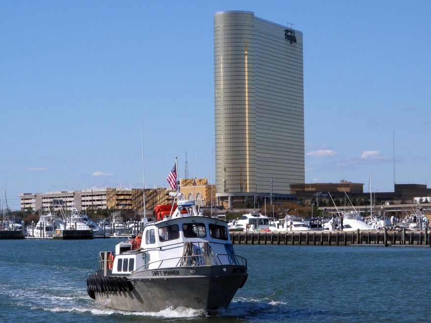 A fishing boat sails past the Borgata casino in Atlantic City, N.J., Thursday Oct. 15, 2015, the same day that New Jersey casino regulators released figures showing the Borgata had won $66.3 million from gamblers in September, up 13.5 percent from a year ago.(AP Photo/Wayne Parry)
