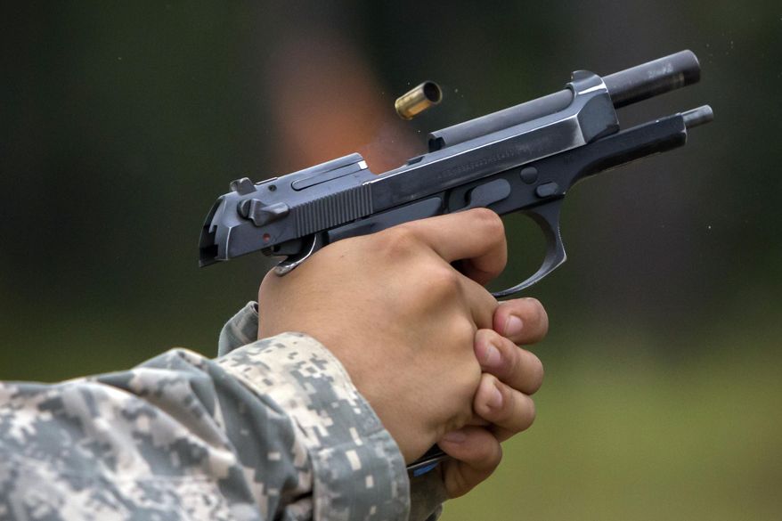 A 9mm case is ejected from the chamber of a Beretta M9 during a qualifying exercise for the 139th Military Police Company, Tuesday, Sept. 29, 2015, in Fort Stewart, Ga. The Army wants to replace its M9, a 9mm semi-automatic handgun adopted during the Cold War. The new gun also will replace the smaller M11. (AP Photo/Stephen B. Morton)