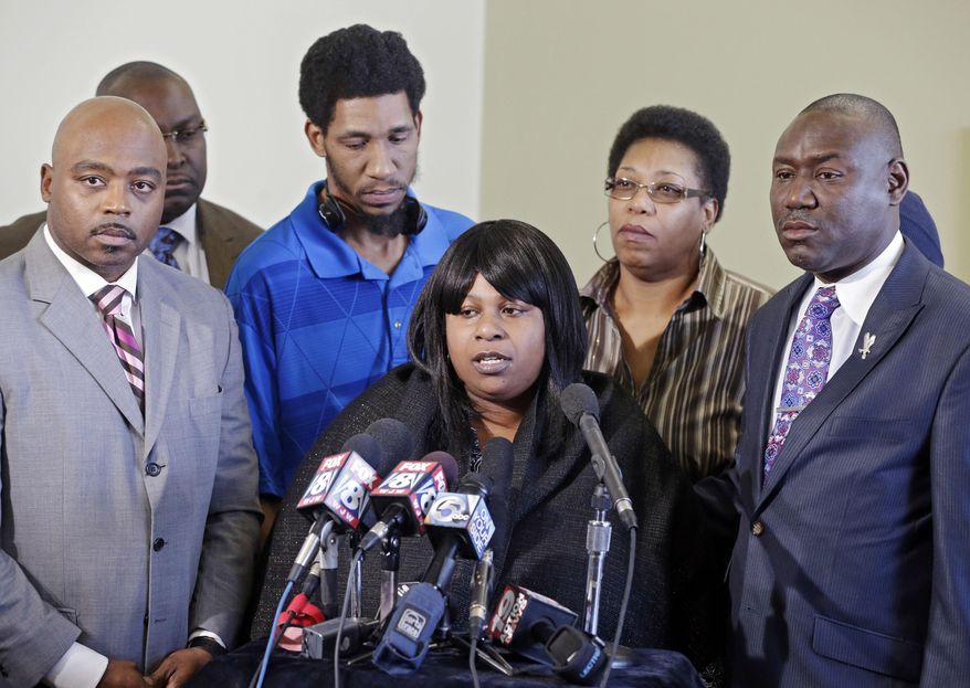 Samaria Rice, center, speaks about the investigation into the death of her son Tamir Rice, at a news conference with attorneys Walter Madison, left, and Benjamin Crump in Cleveland in this Jan. 6, 2015, file photo. (AP Photo/Mark Duncan, File)