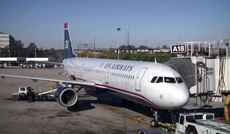 In this image taken from video, US Airways flight 1939, the final US Airways flight, prepares to depart Philadelphia International Airport for Charlotte, N.C. on Friday, Oct. 16, 2015. All future flights will fly under the American Airlines banner, following the completion of a merger announced in 2013. (AP Photo)
