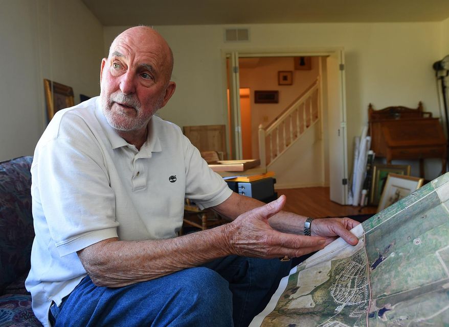 In this Sept. 24, 2015 photo, St. Marie, Mont., developer Pat Kelly looks over a map of the community at the former Glasgow Air Force Base. The community has become mired in a series of bankruptcies and tax liens. (Larry Mayer/The Billings Gazette via AP) MANDATORY CREDIT