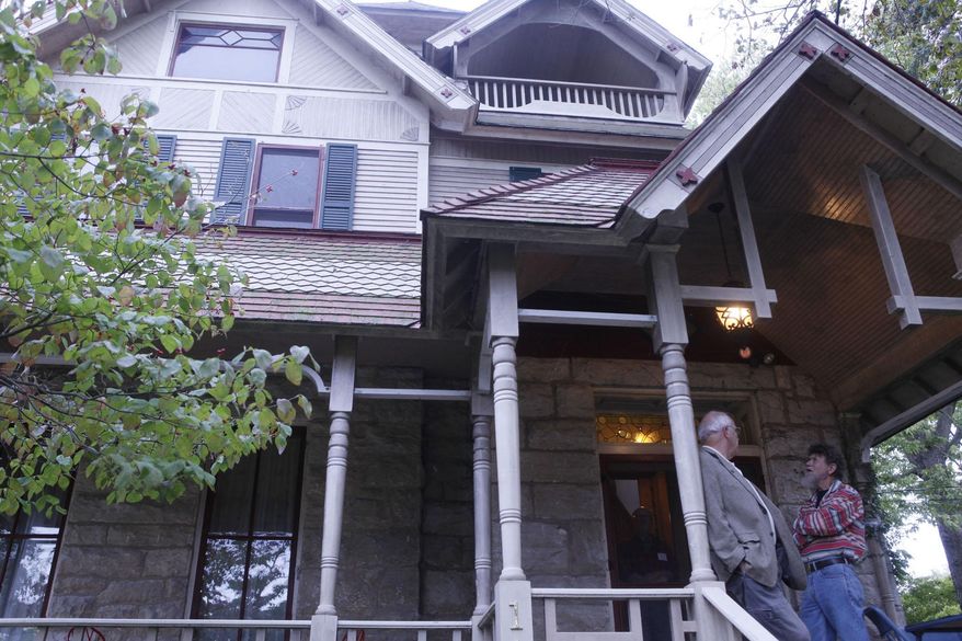 ADVANCE FOR THE WEEKEND OF OCT. 17-18 AND THEREAFTER - In a Tuesday, Sept. 29, 2015 photo, Jerry Rigdon and Jim Spring, grandson to Fred Leopold, linger outside the Aldo Leopold house prior to a tour of the home. One year ago, a group of local conservationists bought Aldo Leopold's childhood home with the hope of turning it into some sort of education center. Now the group has its eye on the neighboring Starker House, and its plans have grown much larger. The group envisions the two houses as a home base for conservation, non-government organizations and wildlife agencies across the country. (AP Photo/The Hawk Eye, Lauren Kastner)