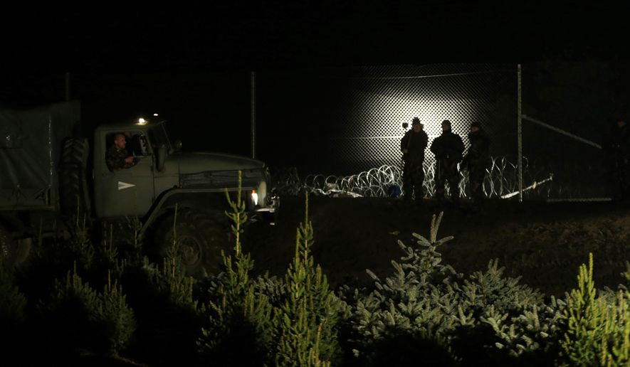 Hungarian soldiers stand by a fence put on the border with Croatia near the village of Zakany, Hungary, Saturday, Oct. 17, 2015. Hungary shut down its border with Croatia to the free flow of migrants on Saturday, a move experts say could leave thousands of people on their way to western Europe stranded in the small Balkan nation. (AP Photo/Petr David Josek)