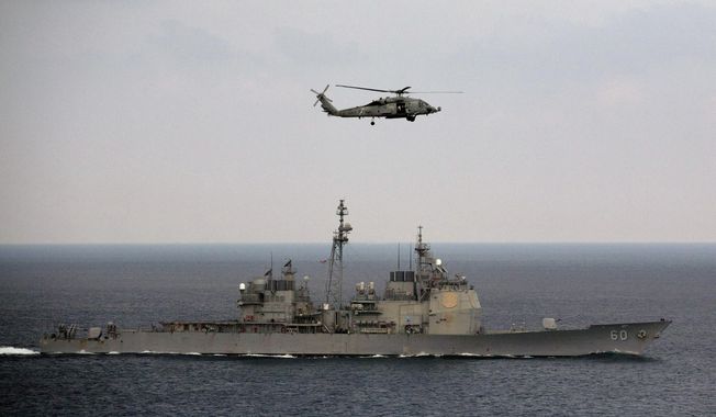 A U.S. Navy helicopter approaches to land on the deck of aircraft carrier USS Theodore Roosevelt (CVN 71), a missile cruiser and a nuclear-powered submarine, as the USS Normady sails in the Bay of Bengal during Exercise Malabar 2015, some 152 miles off eastern coast of Chennai, India, Saturday, Oct. 17, 2015. (AP Photo/Arun Sankar K.) ** FILE **