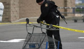 CORRECTS PHOTOGRAPHER- State Trooper sets up a police line using a shopping cart following reports of shots fired near a Wal-Mart store in Wilkes-Barre, Pa., Saturday, Oct. 17, 2015. Police in northeastern Pennsylvania have a suspect in custody. (Dave Scherbenco/The Citizens&#39; Voice via AP) MANDATORY CREDIT