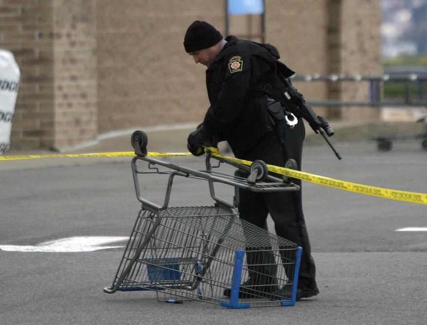 CORRECTS PHOTOGRAPHER- State Trooper sets up a police line using a shopping cart following reports of shots fired near a Wal-Mart store in Wilkes-Barre, Pa., Saturday, Oct. 17, 2015. Police in northeastern Pennsylvania have a suspect in custody. (Dave Scherbenco/The Citizens' Voice via AP) MANDATORY CREDIT