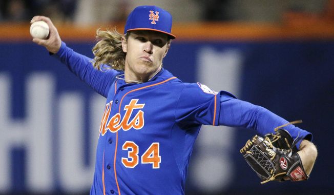 New York Mets pitcher Noah Syndergaard throws during the first inning of Game 2 of the National League baseball championship series against the Chicago Cubs Sunday, Oct. 18, 2015, in New York. (AP Photo/Julie Jacobson)
