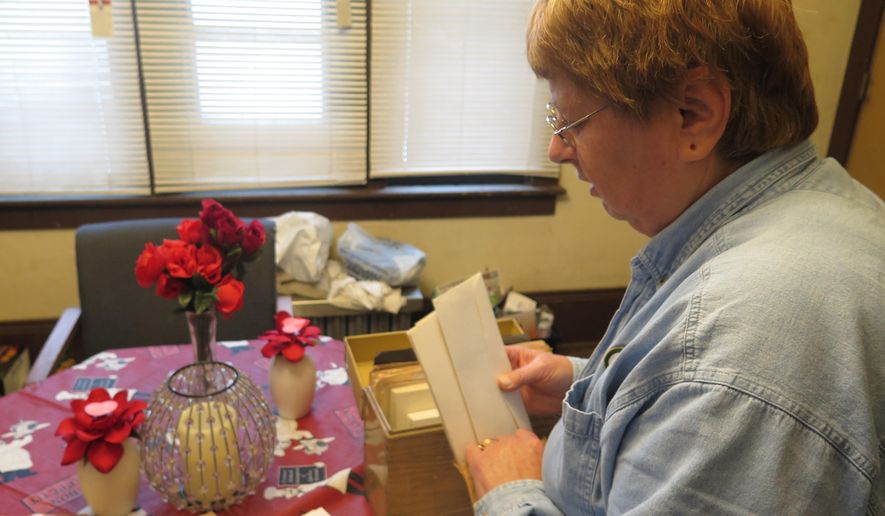 In a Friday, Oct. 16, 2015 photo, Carolyn Tousignant speaks while going through clippings about the 1982 disappearance of her daughter, Carrie Ann Jopek, in her Milwaukee, Wis., home. Authorities have charged Jose Ferreira in the Milwaukee cold case of Jopek more than 30 years ago. The case resurfaced when WISN 12 News reported that Ferreira called the newsroom and described details of the crime. He was charged with second-degree murder and appeared in court Saturday, Oct. 17, 2015. (AP Photo/Greg Moore)