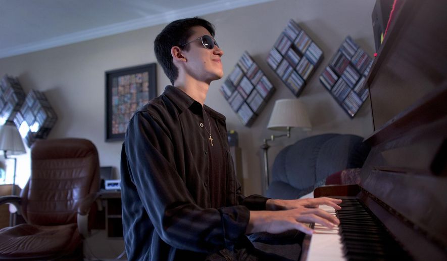 In this photo taken Oct. 29, 2014, Justin Kauflin, an  a award-winning jazz pianist who lost his vision to a rare eye disease at the age of 11, plays piano in Virginia Beach, Va. Kauflin&#39;s relationship with his mentor, legendary trumpeter Clark Terry was chronicled in a documentary, &amp;quot;Keep On Keepin&#39; On,&amp;quot; that won both Best Documentary and Best New Documentary Director Awards at the Tribeca Film Festival in 2014. (L. Todd Spencer/The Virginian-Pilot via AP)  MAGS OUT; MANDATORY CREDIT