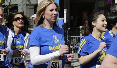 FILE - In this April 19, 2014, file photo, Boston Marathon bombing survivor Heather Abbott, center, dashes from the start line on her running blade during the Tribute Run during Boston Marathon weekend in Boston. The foundation that Abbott created will donate its first custom-made artificial limb to Hillary Cohen, of Walpole, Mass., who will have it fitted on Monday, Oct. 19, 2015. Cohen’s right leg was amputated below the knee in 2014 because of complications from neurofibromatosis. Abbott had her own left leg amputated below the knee after sustaining severe injuries in the 2013 terrorist attack near the marathon finish line. (AP Photo/Charles Krupa, File)