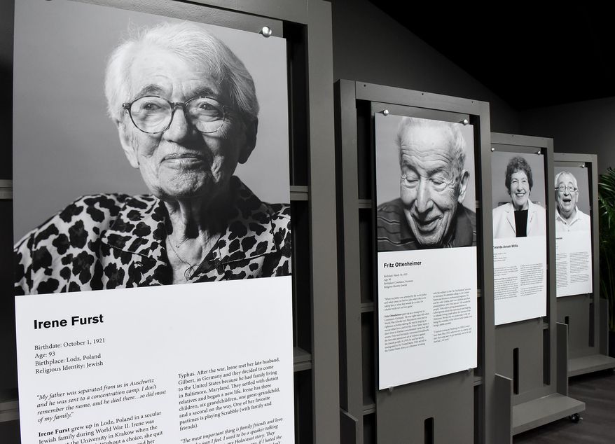 Portraits of Pittsburgh area holocaust survivors and their biographies are on display at the Holocaust Center of Pittsburgh, Sunday, Oct. 18, 2015. They are part of the Center's In Celebration of Life: Living Legacy Project exhibit. The Center held a grand opening Sunday. (Bob Donaldson/Pittsburgh Post-Gazette via AP) MAGS OUT; NO SALES; MONESSEN OUT; KITTANNING OUT; CONNELLSVILLE OUT; GREENSBURG OUT; TARENTUM OUT; NORTH HILLS NEWS RECORD OUT; BUTLER OUT; MANDATORY CREDIT