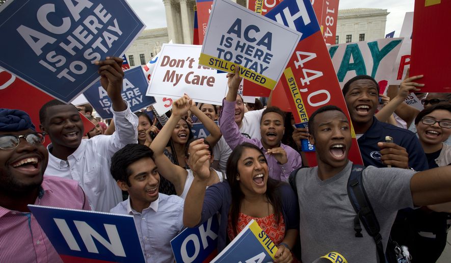 Students cheer outside of the Supreme Court in Washington on June 25, 2015, as they hold up signs supporting the Affordable Care Act (ACA) after the Supreme Court decided that the ACA may provide nationwide tax subsidies. (Associated Press) **FILE**