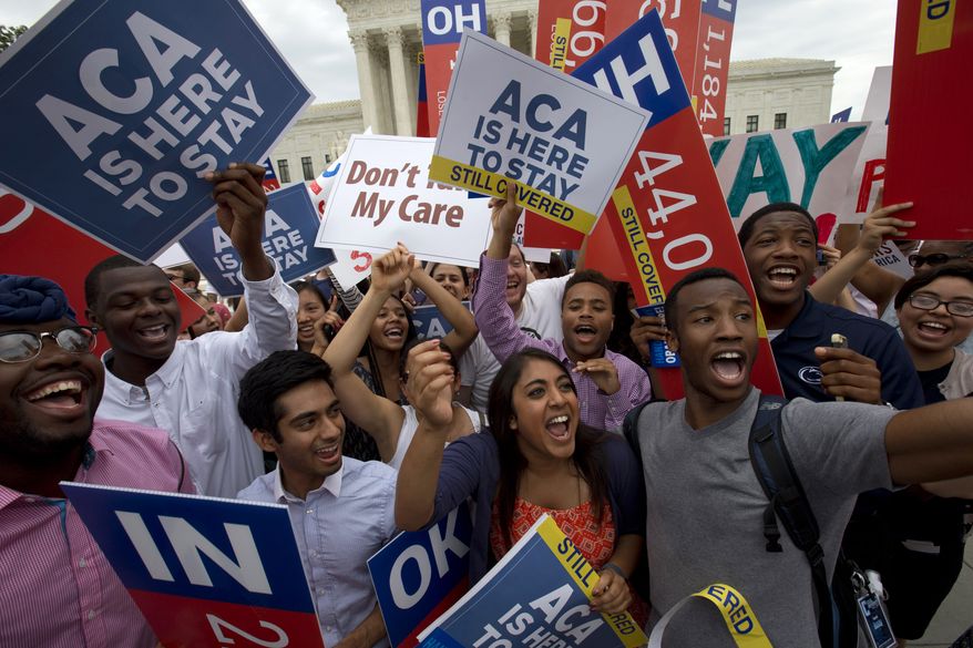Students cheer outside of the Supreme Court in Washington on June 25, 2015, as they hold up signs supporting the Affordable Care Act (ACA) after the Supreme Court decided that the ACA may provide nationwide tax subsidies. (Associated Press) **FILE**