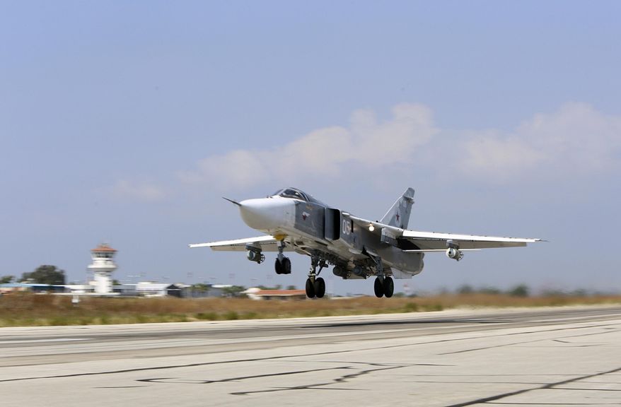 FILE - In this Oct. 3, 2015, file photo, a Russian SU-24M jet fighter armed with laser guided bombs takes off from a runaway at Hmeimim airbase in Syria. Russia and the United States signed an agreement Oct. 20 designed to minimize the risk of collisions and other dangers as both countries carry out airstrikes in Syria. (Alexander Kots, Komsomolskaya Pravda, Photo via AP)