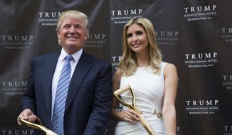 In this July 23, 2014, file photo, Donald Trump and his daughter Ivanka Trump pose for photographs during a ground-breaking ceremony for the Trump International Hotel on the site of the Old Post Office in Washington. (AP Photo, File)